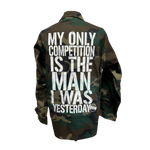 Close-up of a jacket with the text 'My only competition is the man I was yesterday', capturing the essence of personal growth and ambition by KIC NYC.